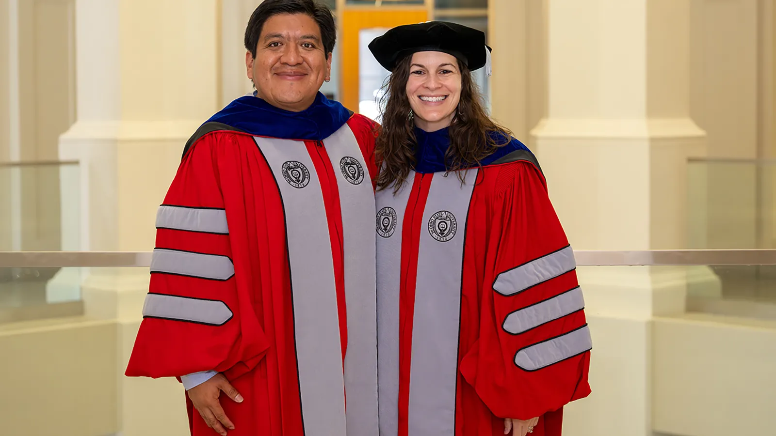 2 new phd students posing for photo togther