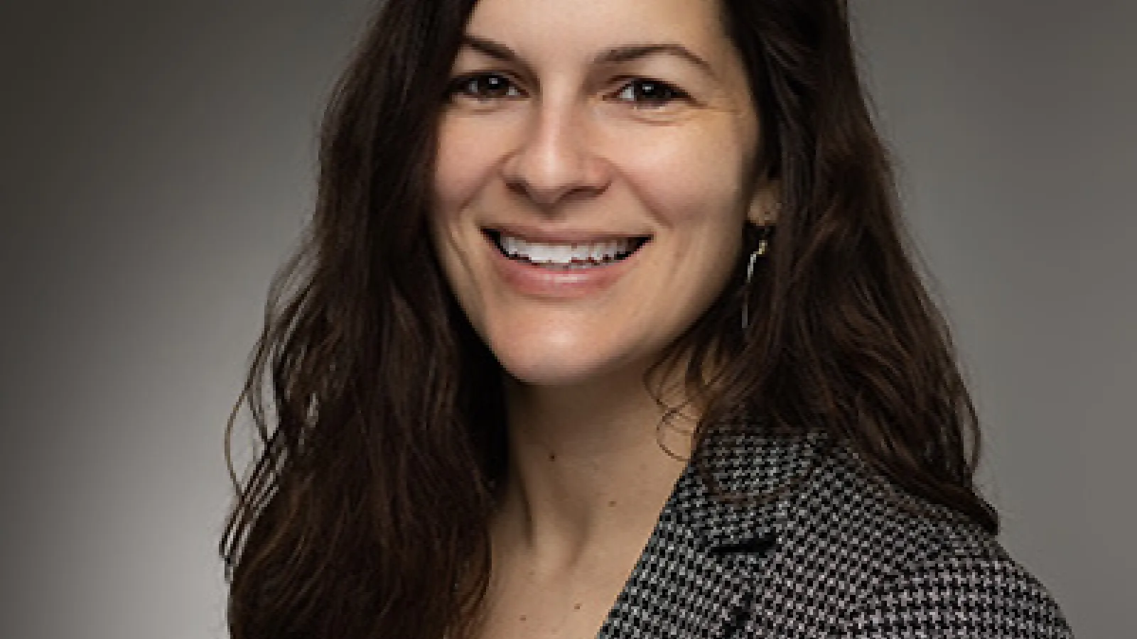 Alyssa, brown hair wearing a brown blazer