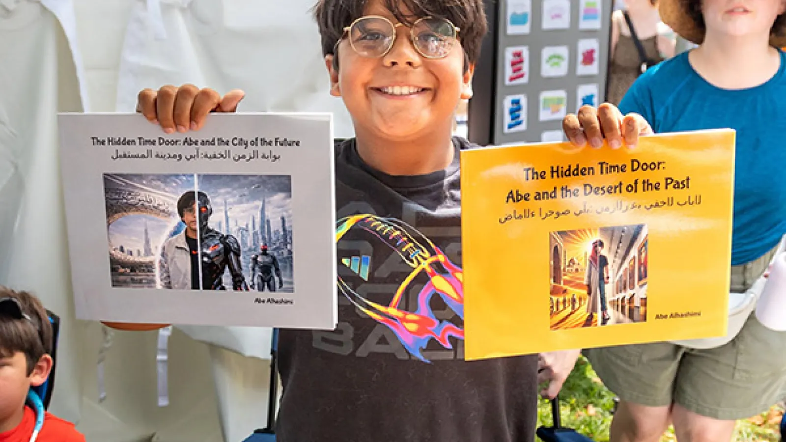 Child holding up two books