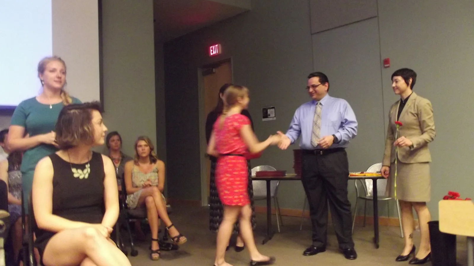 Student receiving diploma from Department Chair