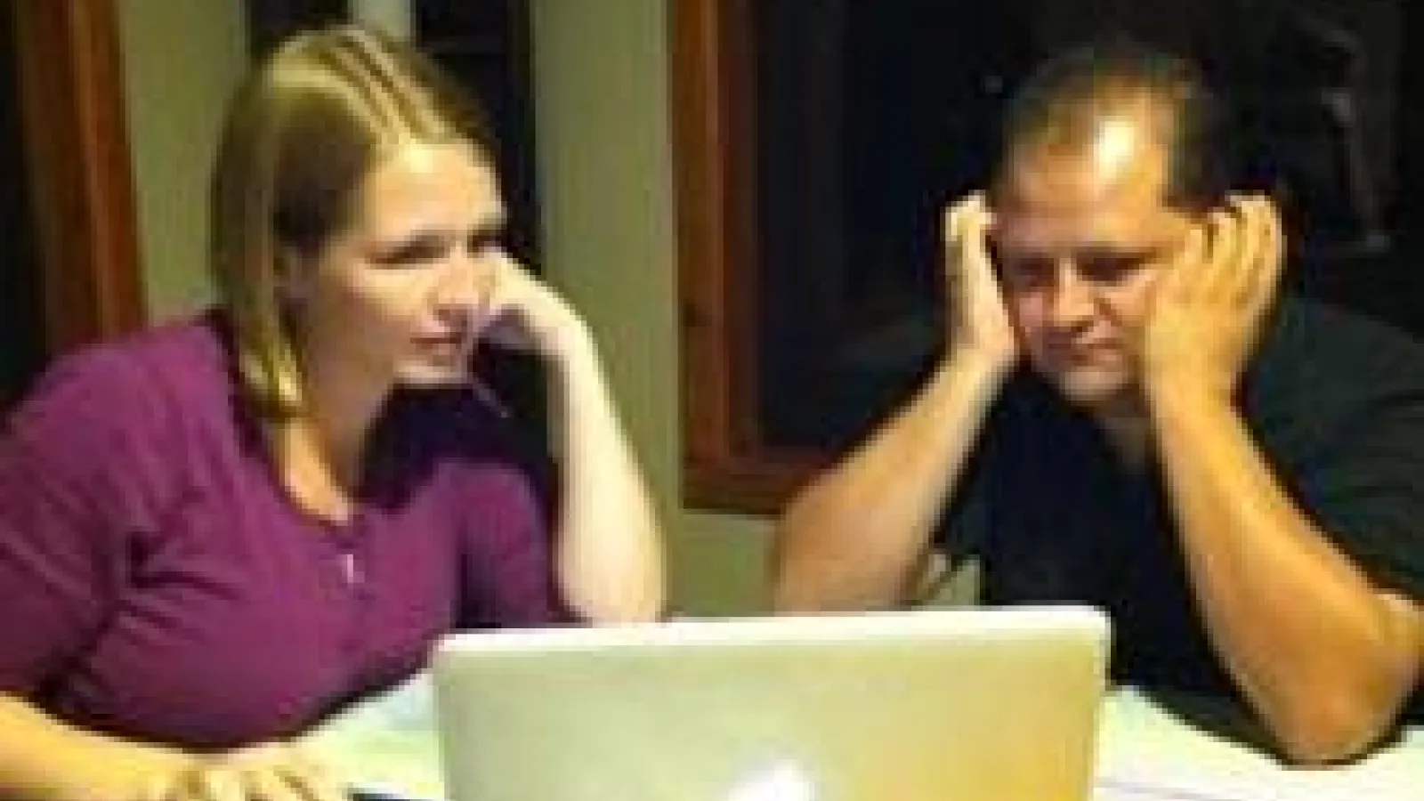 two people working on laptop