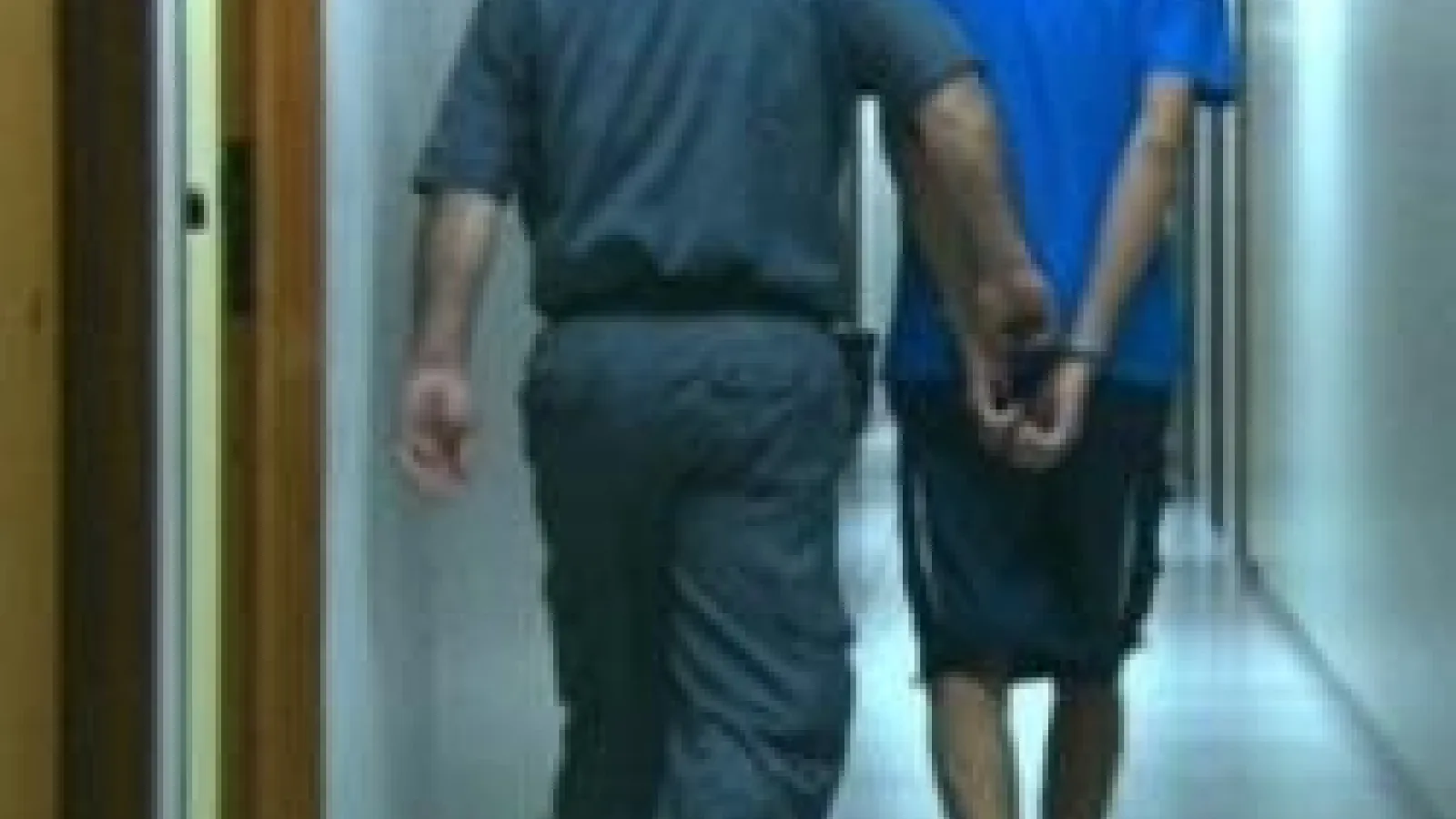 Man walking in handcuffs