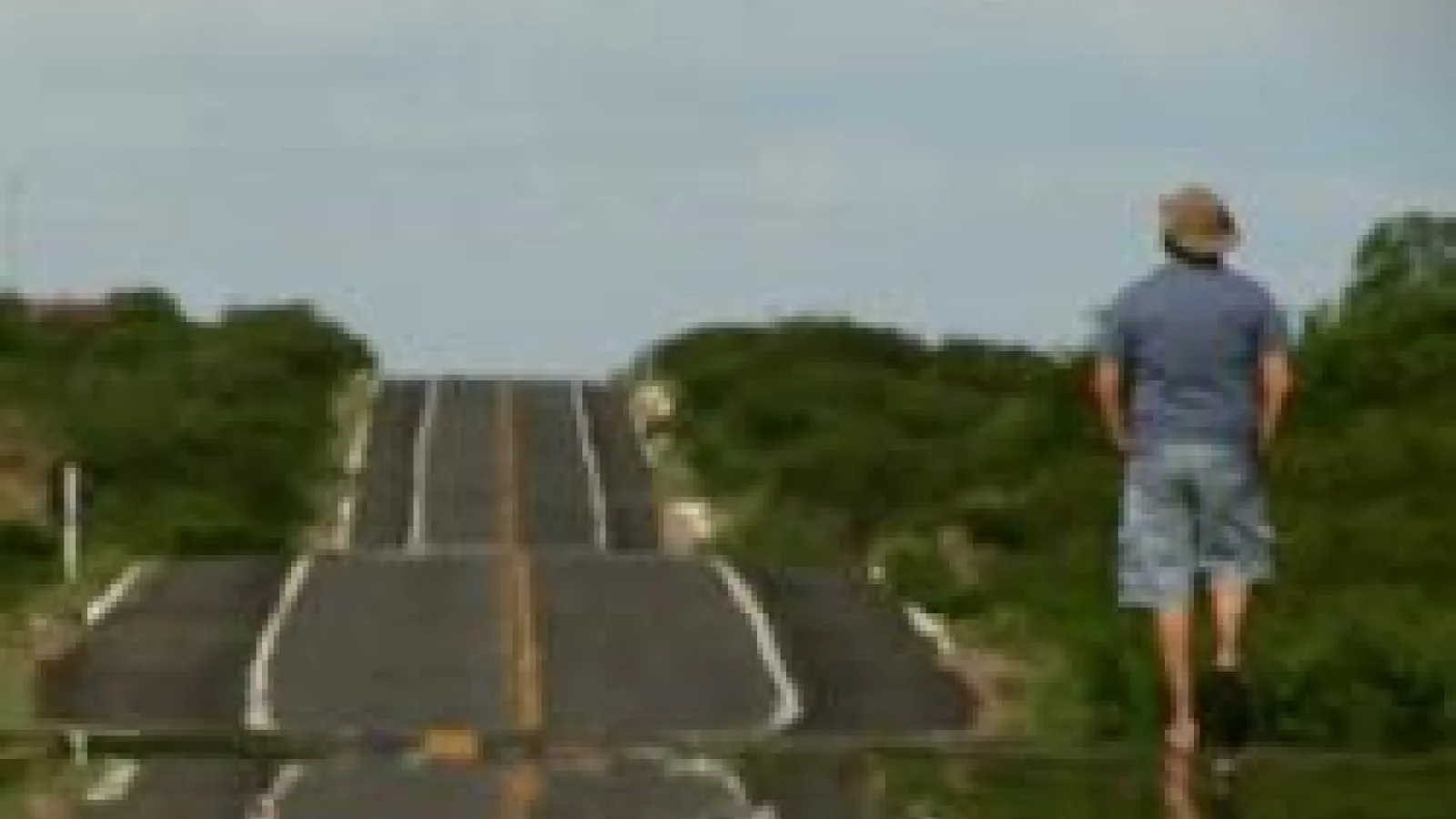 Man walking on side of a road