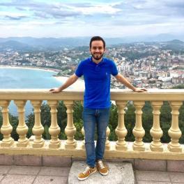 Anthony Palmiscno in front of a scenic coast