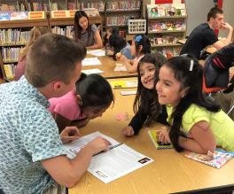 OSU Student Reading Storybook with Salem Elementary Students