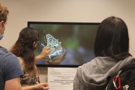 Dr. Wibbelsman using technology to display a cultural artifact from the collection