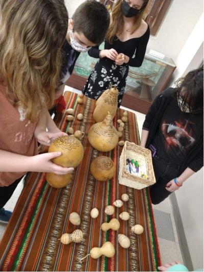 Scholars interacting with gourds