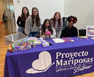 CMA art event, 5 female students sitting a table with a purple tablecloth