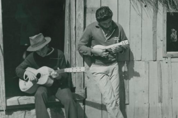 Two men playing guitars
