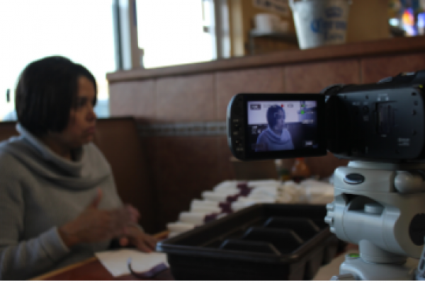 Woman filming story using video camera