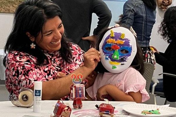 Trying on papier-mache mask