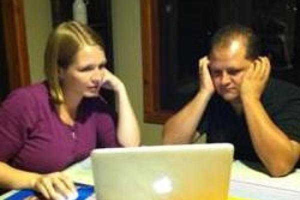 two people working on laptop