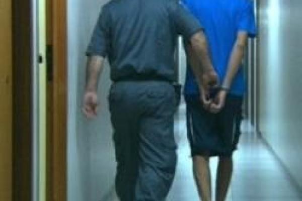 Man walking in handcuffs