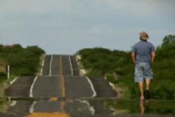 Man walking on side of a road