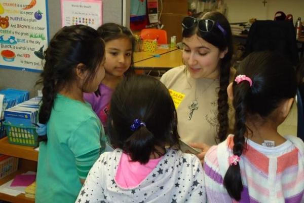 Ohio State Spanish student Rachel Cannata reads a story to a group of first-graders at Salem Elementary School. Courtesy: Jill Welch